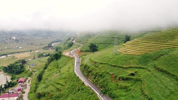 Road on the Hills in the Countryside with Village and Rice Terraces on Foggy Day alt