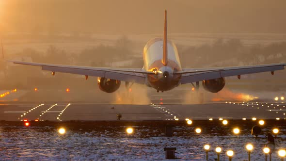 Commercial Airplane Landing at Sunset