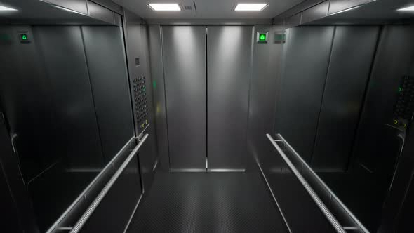 Empty, modern elevator with brushed steel walls traveling upwards in a loop 4KHD alt
