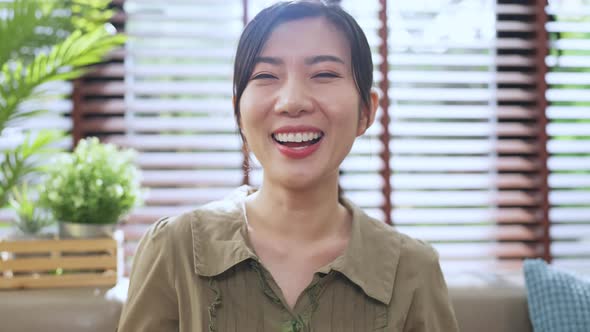 Beautiful smiling and laugh confident asian ethnic woman pretty face looking at camera