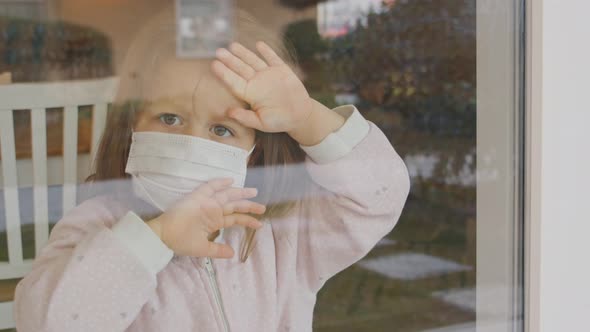 Quarantined Girl Is Looking Through The Window alt