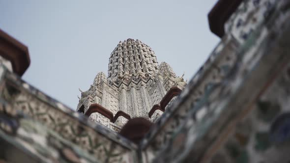 Tilted Up Shot of Wat Arun Buddhist Temple in Bangkok Thailand alt