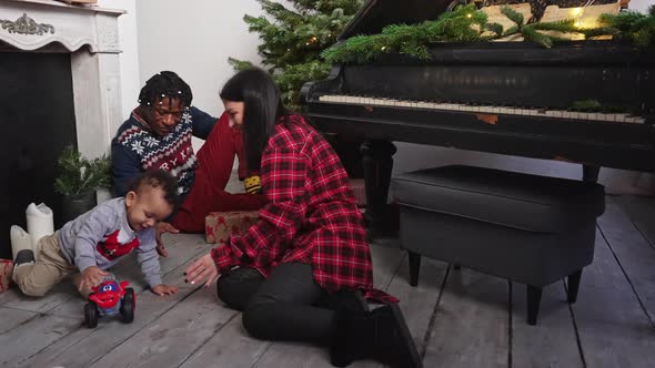 Adorable Mixed Race Toddler Playing with His Brand New Toy Car alt