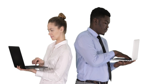 Couple Back to Back Standing and Working on Laptops On alt