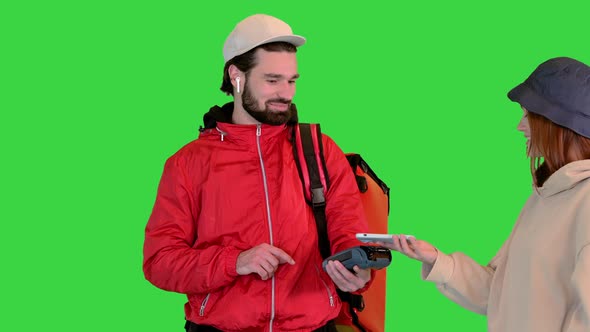 Delivery Man Holding Payment Terminal Young Girl Paying for Delivery on a Green Screen Chroma Key alt