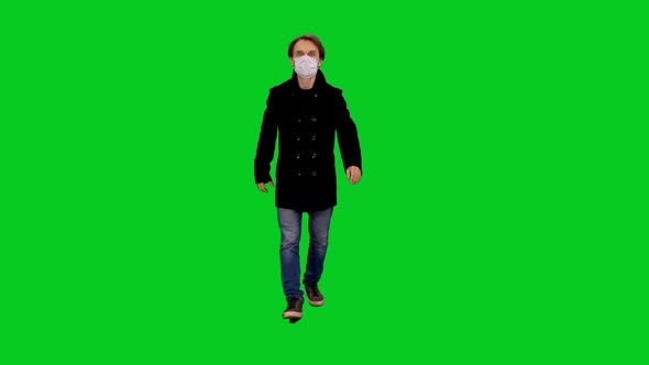 Man In Casual Clothing And Protective Mask Walking on Green Screen