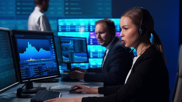 Team of brokers is working in office using workstation and analysis technology. alt