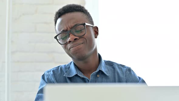 Disappointed Young African Man reacting to Loss on Laptop alt