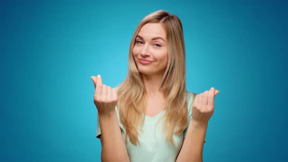 Young Woman Showing Gesture of Wasting Money Against Blue Background Materialist Shopping Concept alt