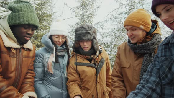 Young Friends Preparing Marshmallows of Fire in Winter Forest alt