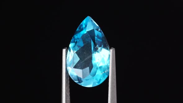 Natural Blue Topaz Pear Cut in the Turning Tweezers