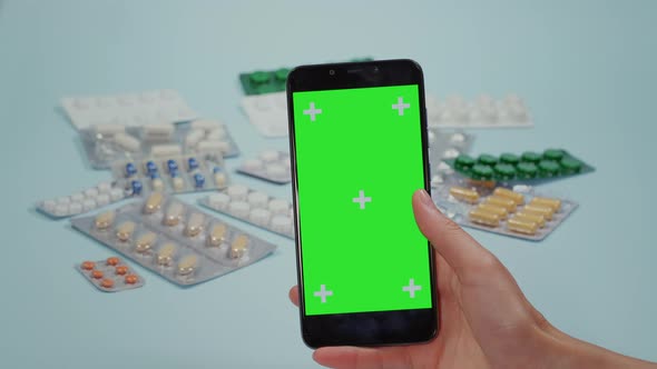 Women Hand Swipes On The Smart Phone Green Screen alt