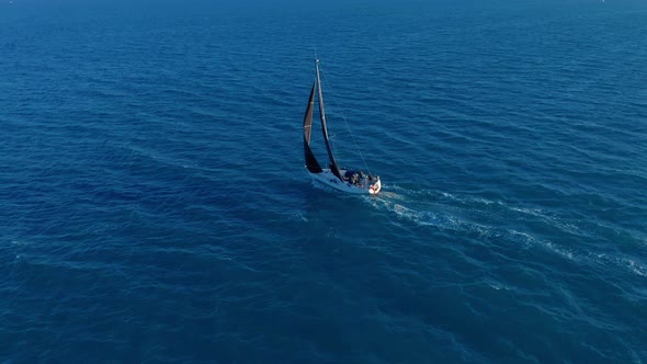 Aerial View. Sailing Yachts with White Sails in the Open Sea. alt
