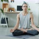 Slow Motion Portrait of Attractive Guy Meditating at Home and Looking at Camera - VideoHive Item for Sale