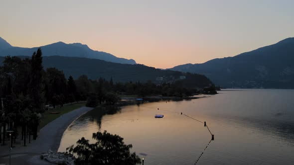 Beautiful aerial shot of lake  garda at sunset. Aerial view of a landscape in Italy with lake, mount alt