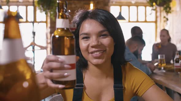 Latin American woman talking to the camera inside pub