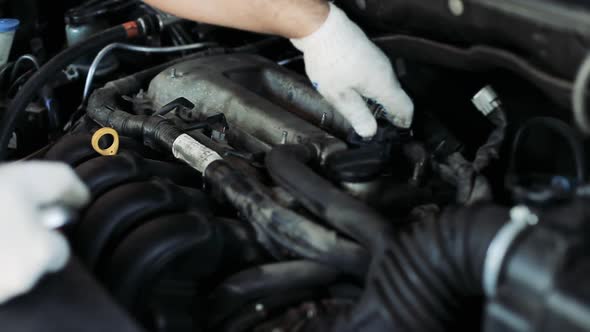 Auto Mechanic Checking an Internal Combustion Engine.