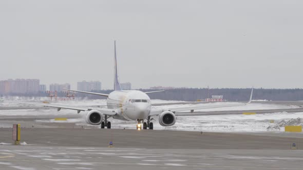 Boeing 737-800 of Mongolian Airlines Taxiing on Runway, Winter View alt