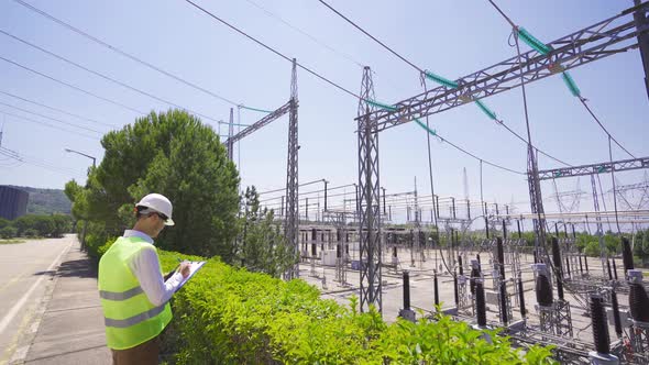 Engineer inspecting the switchyard. alt