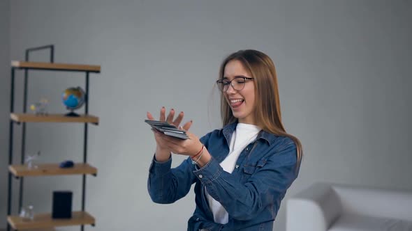 Handsome Smiling Woman Throwing Money for Travel alt