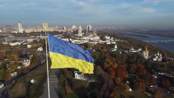 the national flag of Ukraine and the statue of liberty over Kyiv, panorama right