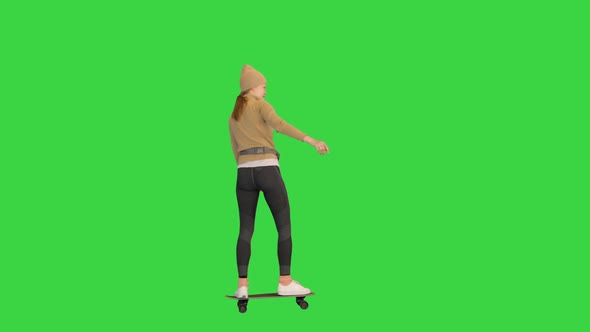 Stamboom Tienerjaren Interpretatie Sporty Woman in Warm Clothes Skateboarding By on a Green Screen Chroma Key  by FunKeyRec