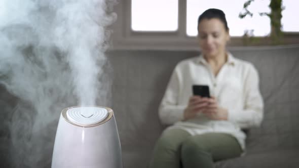 Woman Enjoy Aroma Diffuser in House alt