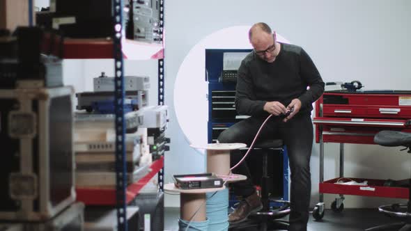 Electric Engineer in workshop cutting wire