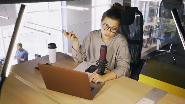 Woman Talks in Microphone on Air in Studio