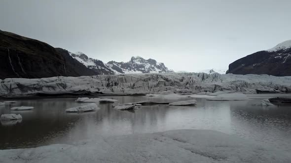 Cloudy Aerial Glacier, mountains, water and ice