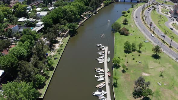 AERIAL - Boats on a river in Tigre, Buenos Aires, Argentina, forward circle pan alt