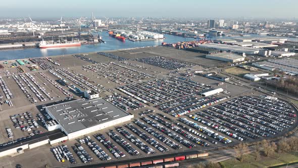 Aerial of a Automotive Car Terminal Parking Lot Storage Loading Area Ready for Distribution in the alt