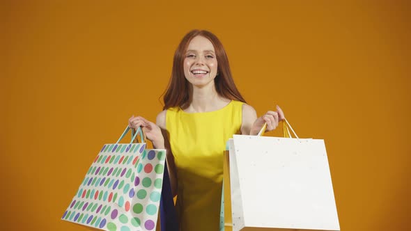 Excited with Joyful Emotions the Customer of a Fashion Store a Smiling Young Woman Holding a Lot of