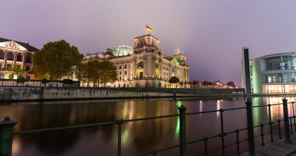 Sunrise hyper lapse of the Reichstag government building in central Berlin, spree river water front alt