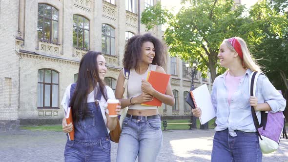 Girlfriends (or students) walking near the college.