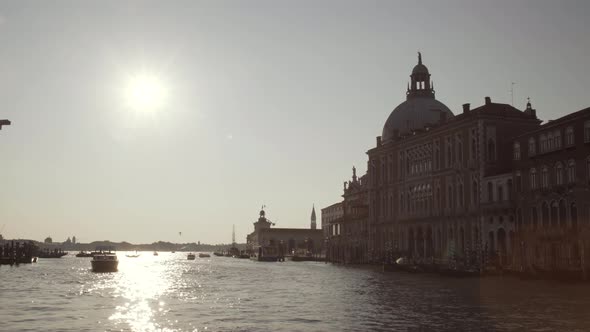 Sailing towards Basilica di Santa Maria della Salute on a beautiful sunny morning, water reflections alt