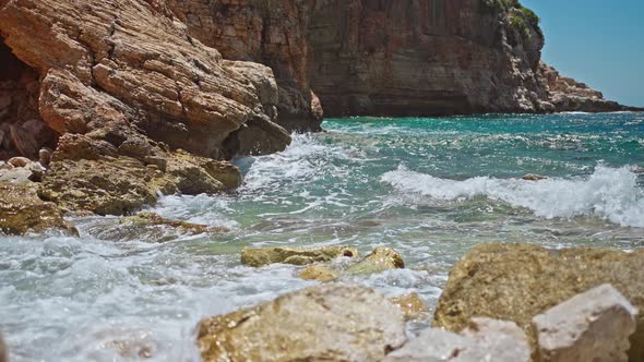 Slow Motion Footage Tropical Island and Sea Waves Crashing and Foaming Against Rocky Beach alt
