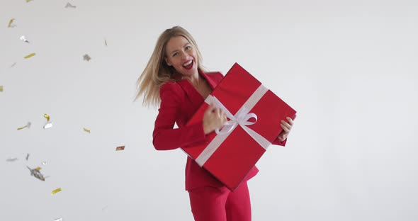 Jolly Woman in Red Dancing with Gift.