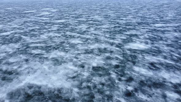 Beautiful top view of the northern arctic nature. Endless water surface, covered with ice and snow. alt