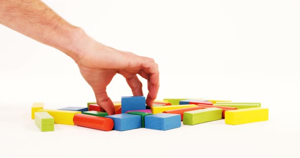 Man hand playing building blocks alt