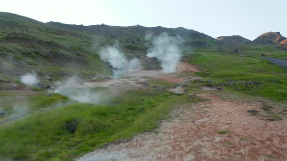 Birds Eye Flying Toward Geyser Geothermal Area with Steaming Craters in Iceland alt