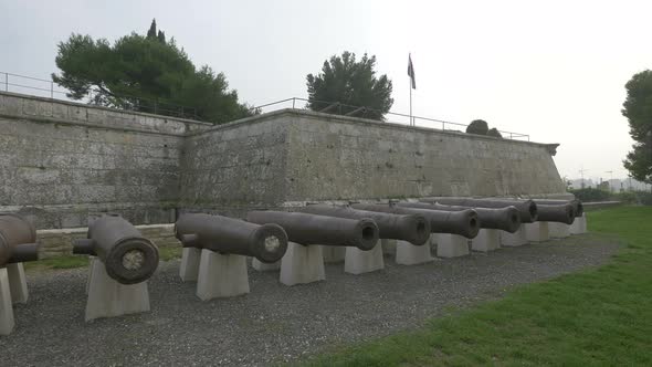 Old cannons by the stone walls at Pula Castle alt