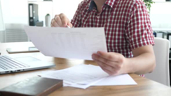 Male Works with Paper Documents