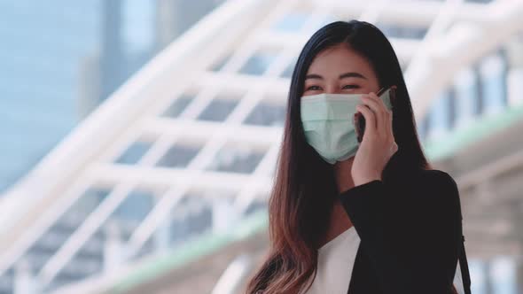 Business woman with hygiene mask turn back and use mobile phone to contact with someone alt
