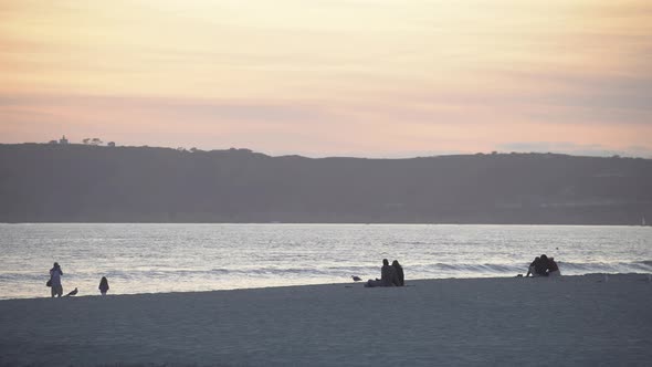 Sitting on the beach at sunset alt