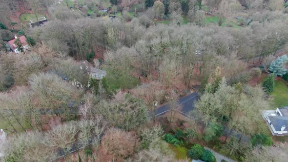 Aerial View of Big Villas with Garden Surrounded By Forest During Winter Season alt
