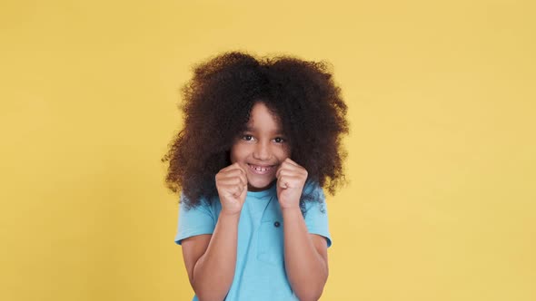 Excited Intrigued Face of Little Darkskinned Girl with Curly Lush Hair alt