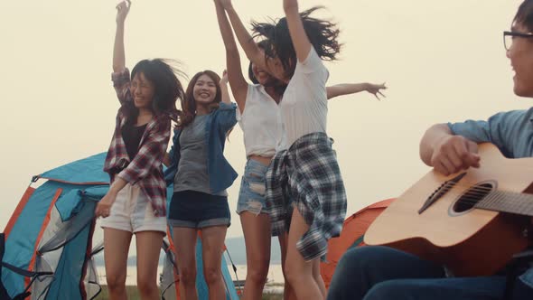 Group of Asia best friends teenagers give high five and dancing enjoy with guitar music happy.