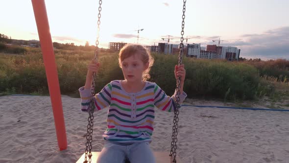 Girl On Swing Outdoors alt