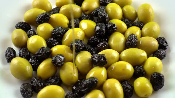 Pouring Olive Oil on Olives